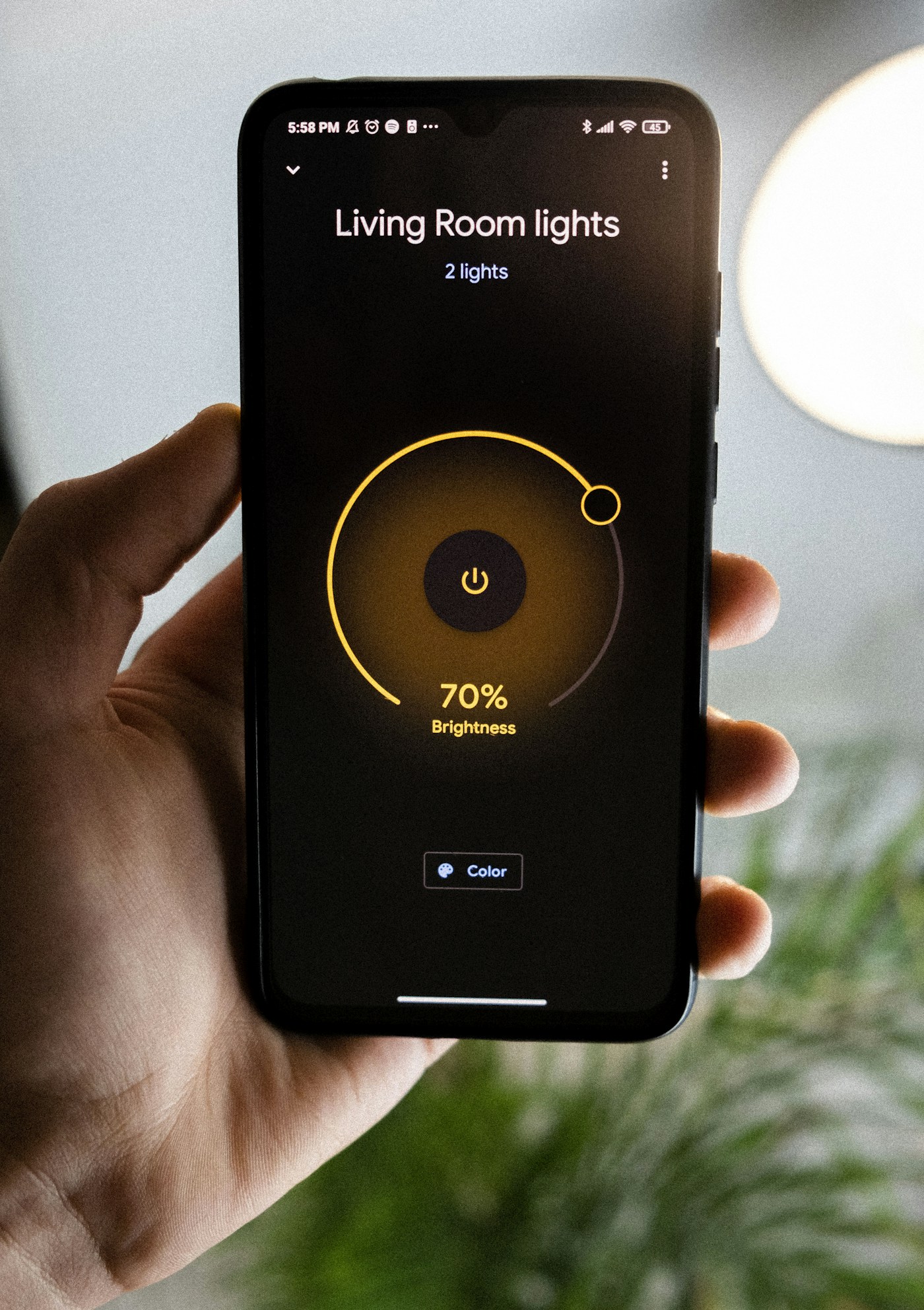 A phone controlling living-room light brightness