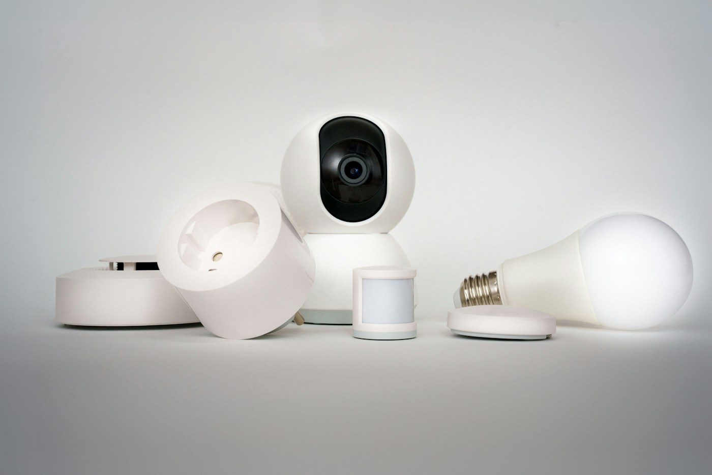 A camera, smart bulb and small sensors on a table