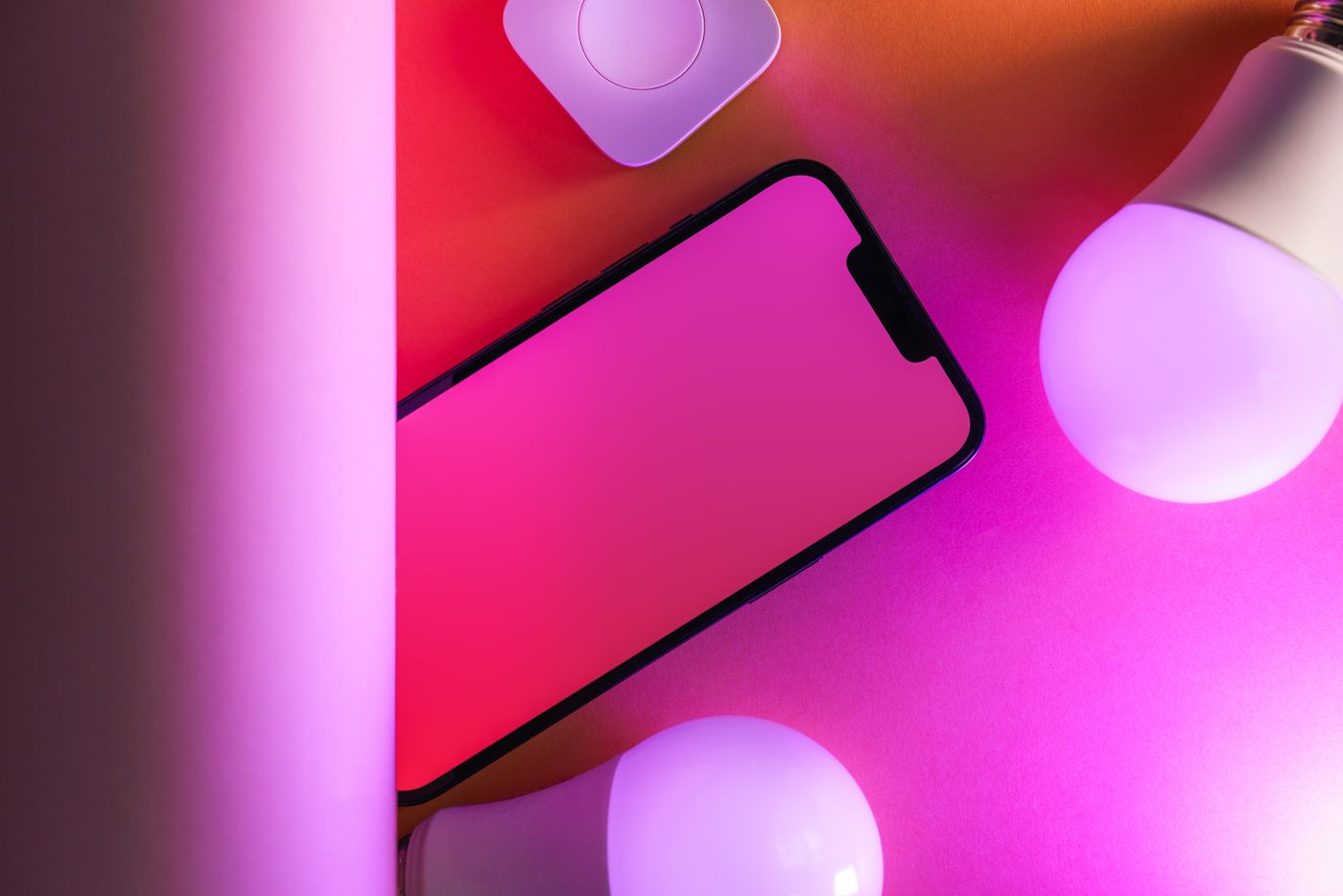 A phone beside connected lighting devices