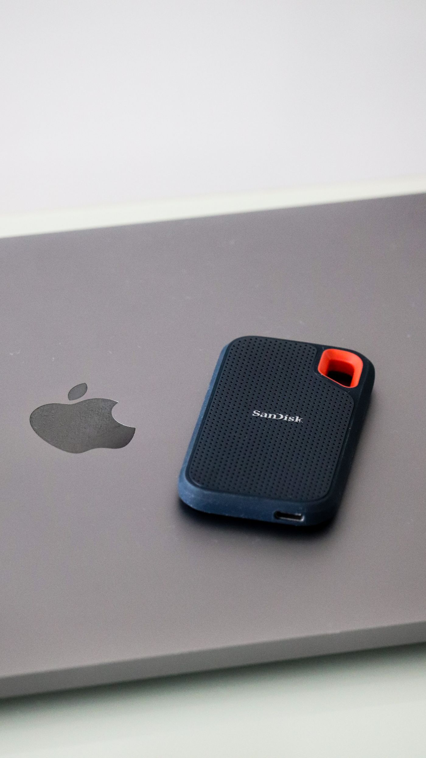 Portable solid-state drive resting on a laptop