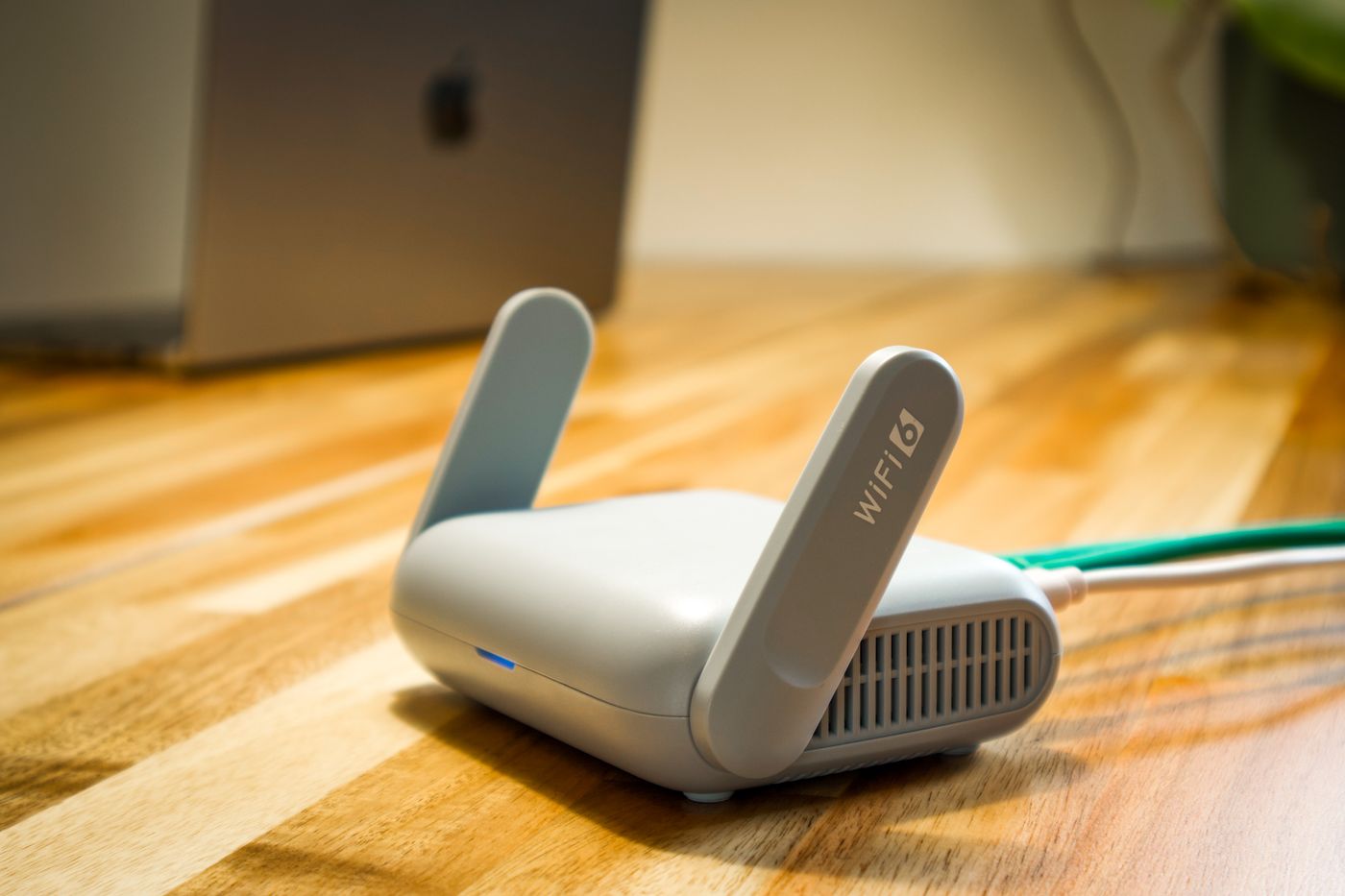 Wireless router and connection cable on a wooden desk
