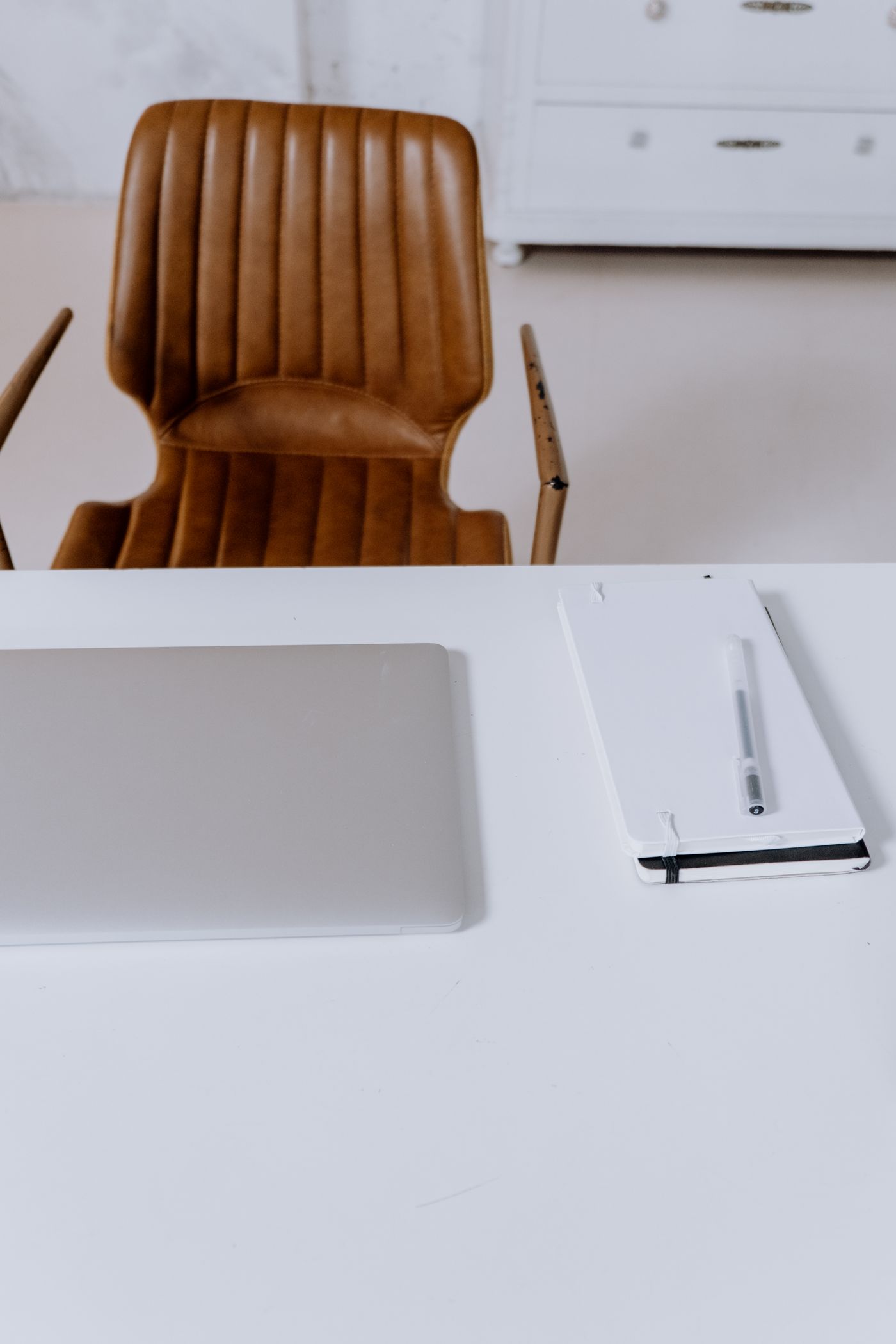 Laptop and notepad ready for writing a support request