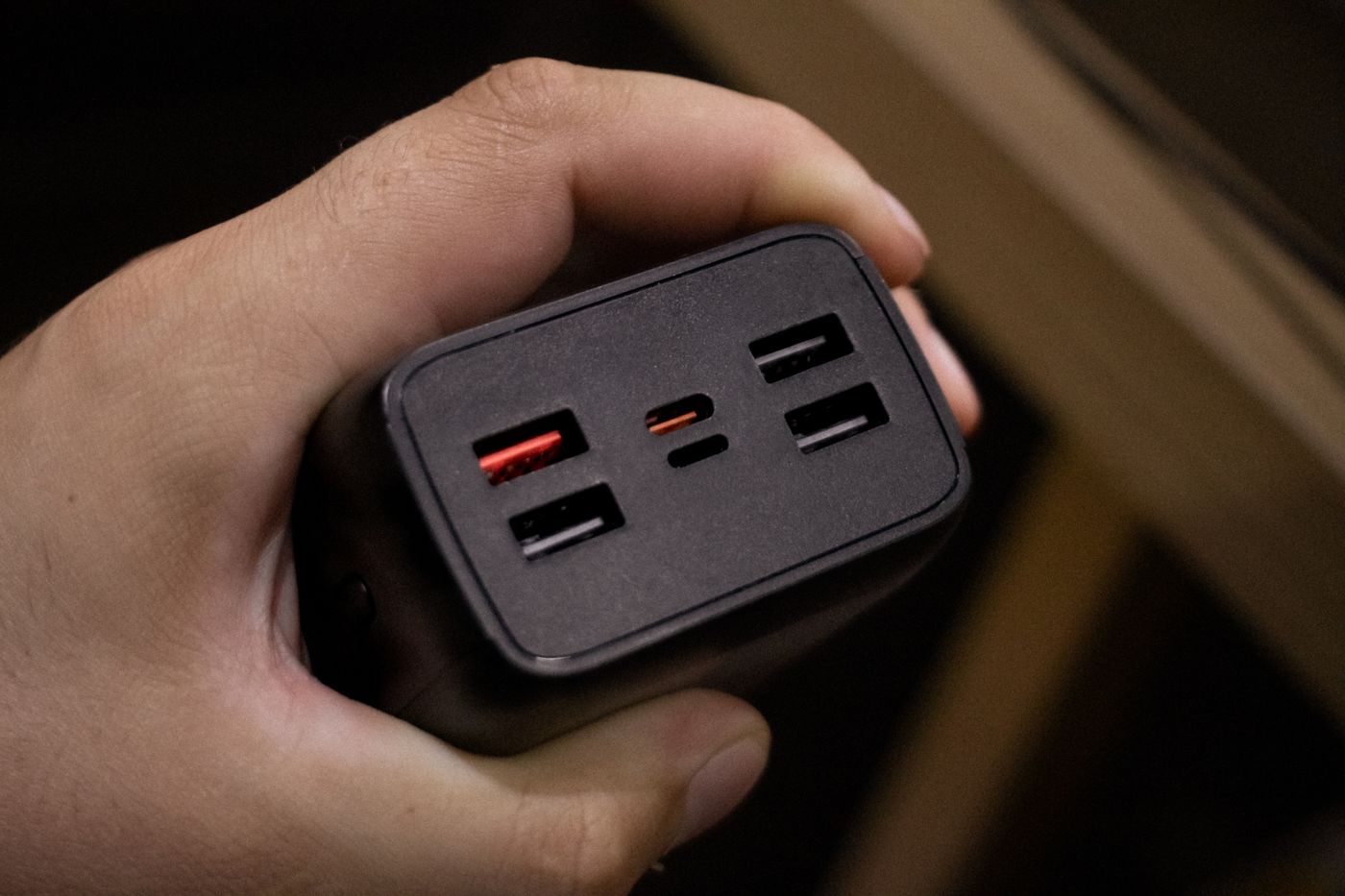 Multi-port USB power adapter held in a hand