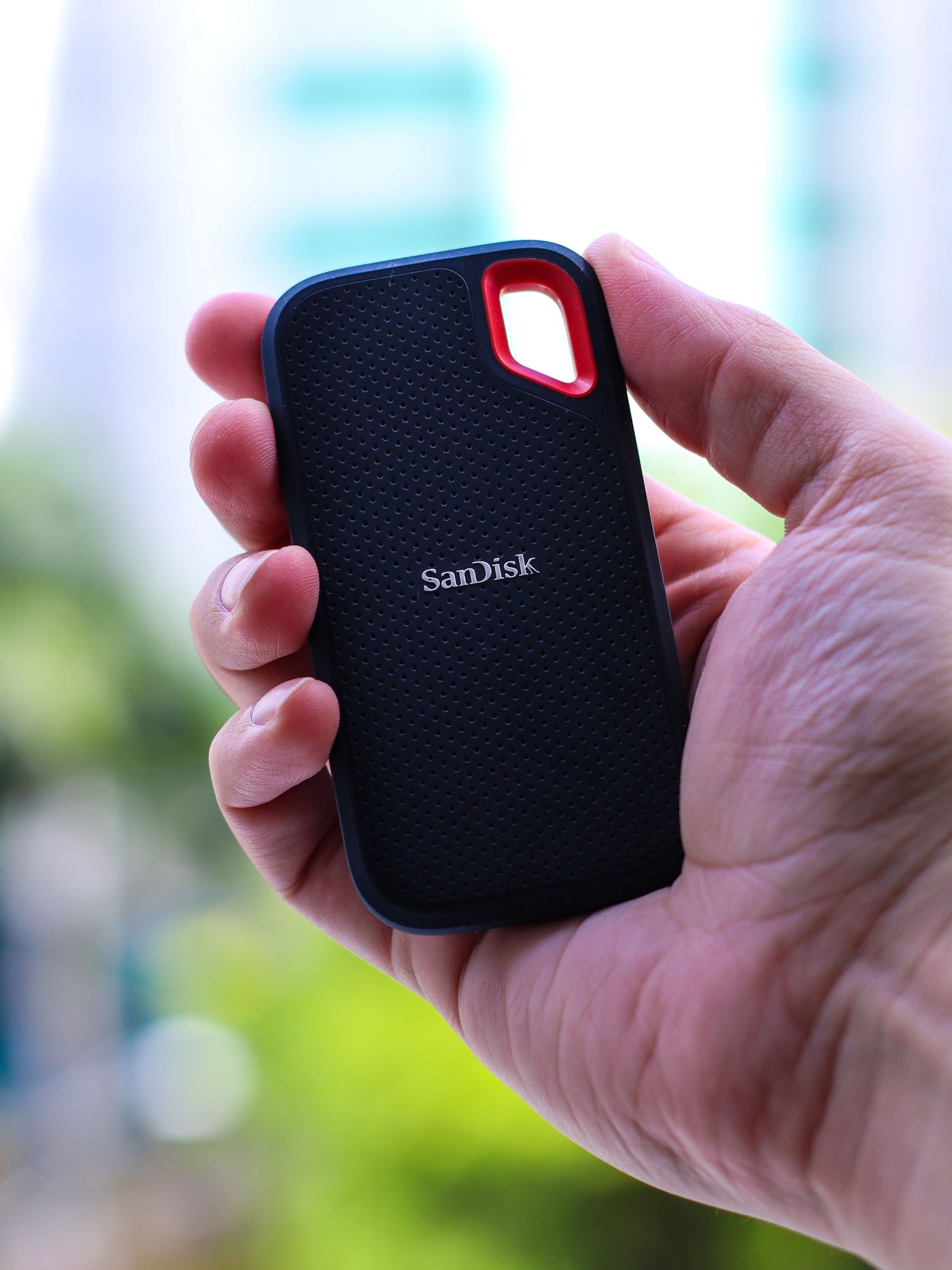 Portable solid-state drive held in a hand